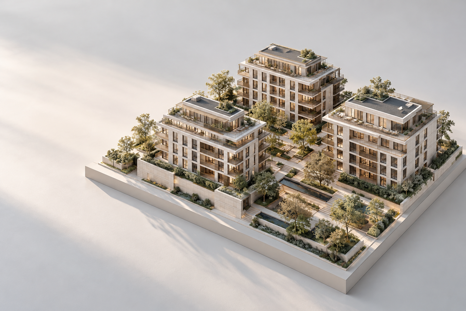 Konzeptionelles Architekturmodell eines modernen Wohnquartiers mit drei Gebäuden und begrüntem Innenhof.